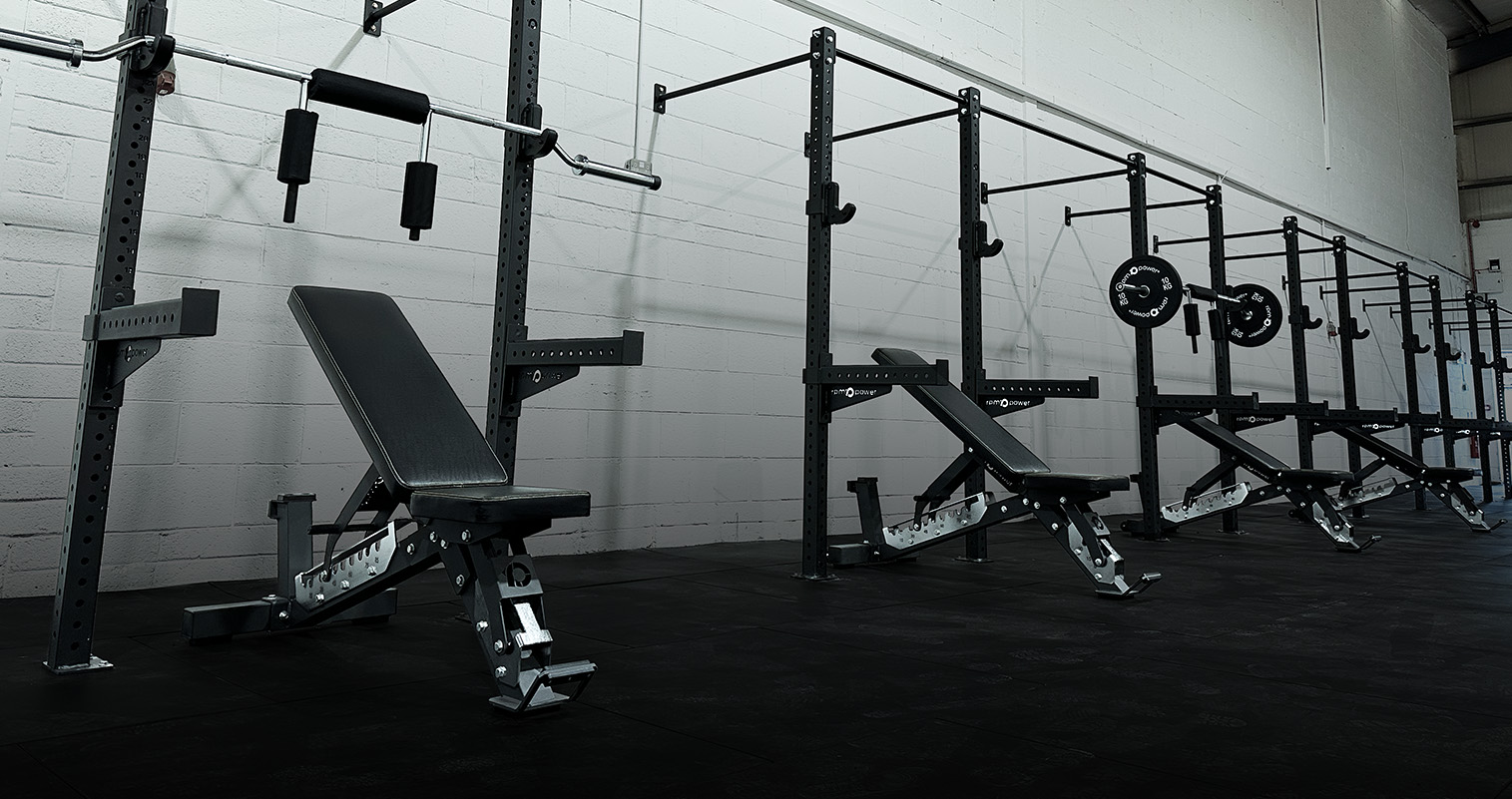 Wall mounted bay rigs set of 4 in a commercial gym setting.