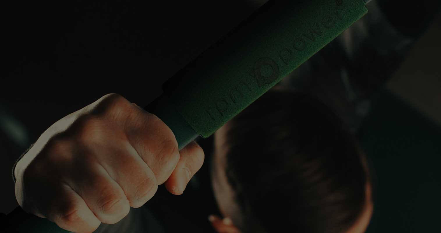 Close up of RPM Power adjustable pull-up bar with a person using it.
